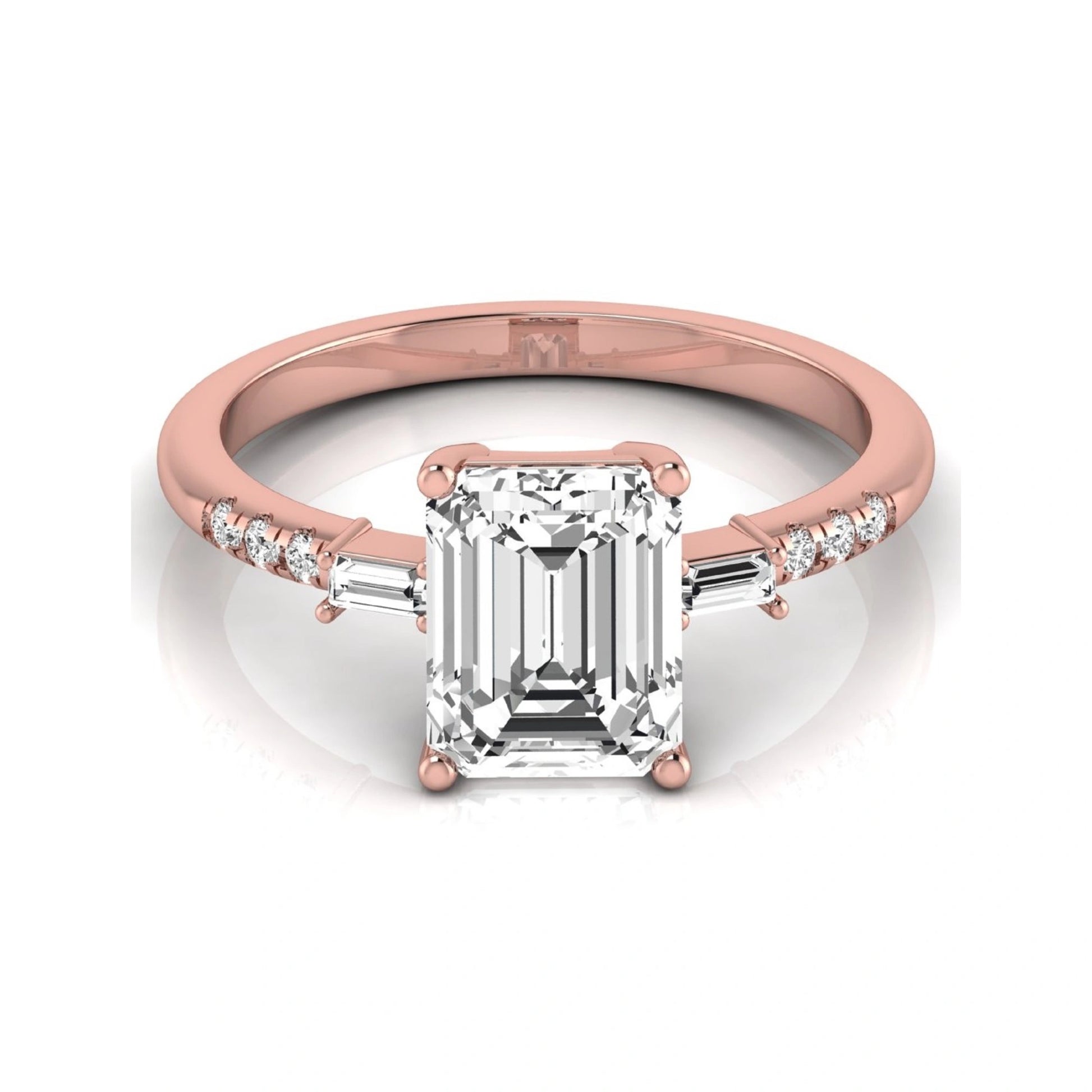 Emerald cut lab grown diamond engagement ring featuring an IGI certified center diamond with baguette and round side diamonds in a classic four-prong three-stone setting in rose gold