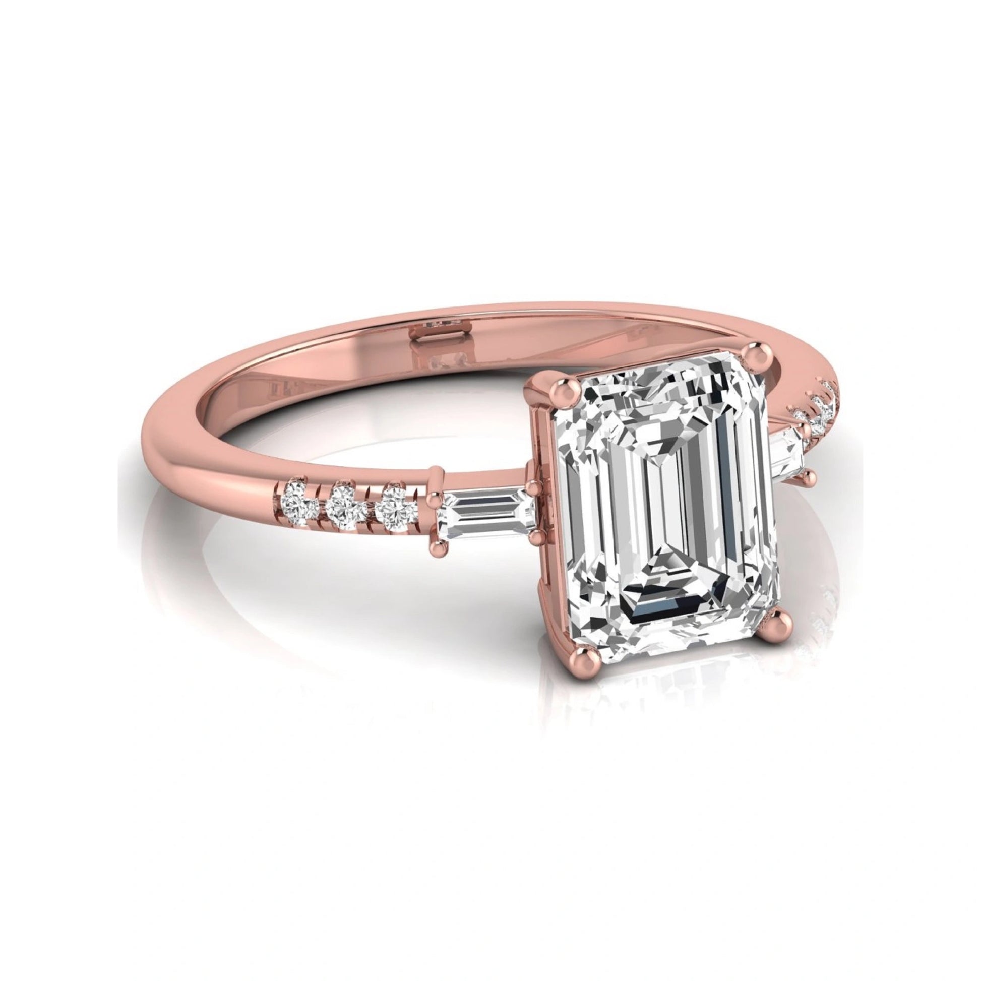 Emerald cut lab grown diamond engagement ring featuring an IGI certified center diamond with baguette and round side diamonds in a classic four-prong three-stone setting in rose gold