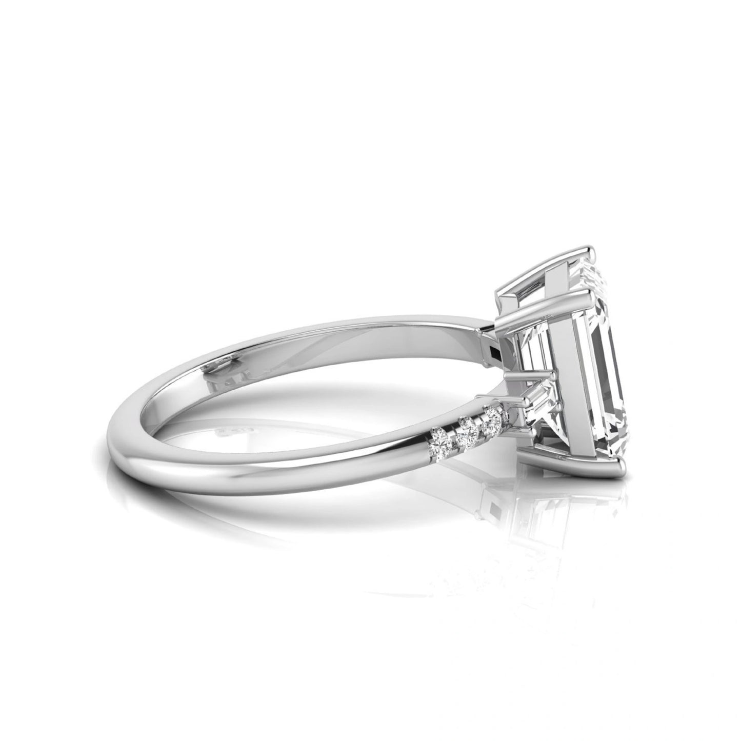 Emerald cut lab grown diamond engagement ring featuring an IGI certified center diamond with baguette and round side diamonds in a classic four-prong three-stone setting in white gold