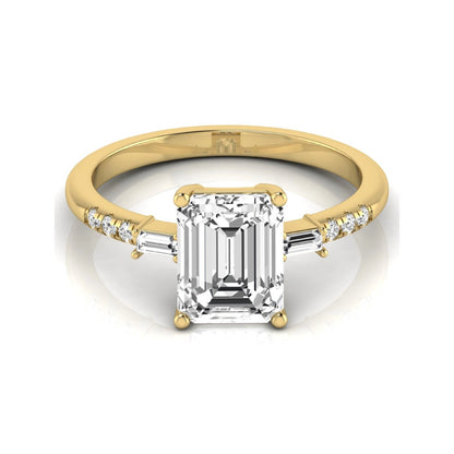 Emerald cut lab grown diamond engagement ring featuring an IGI certified center diamond with baguette and round side diamonds in a classic four-prong three-stone setting in yellow gold