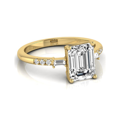 Emerald cut lab grown diamond engagement ring featuring an IGI certified center diamond with baguette and round side diamonds in a classic four-prong three-stone setting in yellow gold