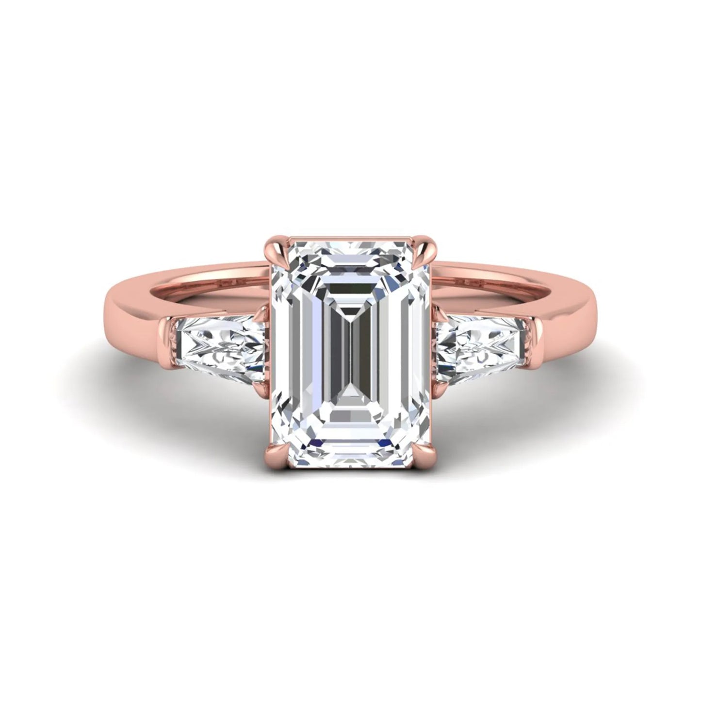 Emerald three stone prong set lab grown diamond engagement ring featuring a 3.00 carat emerald cut center diamond with tapered baguette side diamonds in rose gold finish.