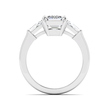 Emerald three stone prong set lab grown diamond engagement ring featuring a 3.00 carat emerald cut center diamond with tapered baguette side diamonds in white gold finish.