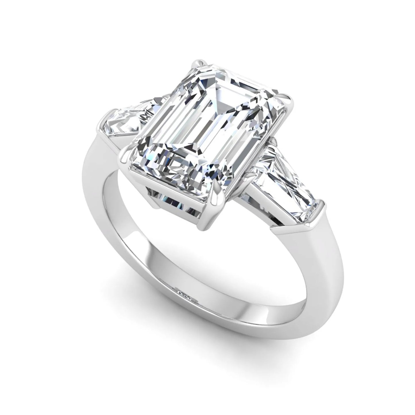 Emerald three stone prong set lab grown diamond engagement ring featuring a 3.00 carat emerald cut center diamond with tapered baguette side diamonds in white gold finish.