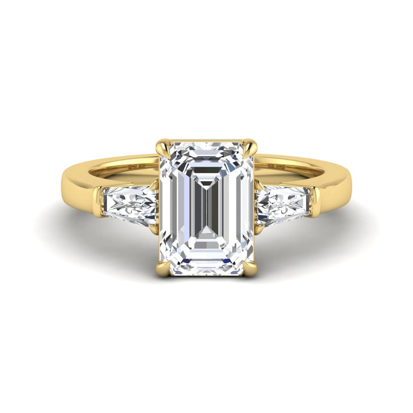 Emerald three stone prong set lab grown diamond engagement ring featuring a 3.00 carat emerald cut center diamond with tapered baguette side diamonds in yellow gold finish.