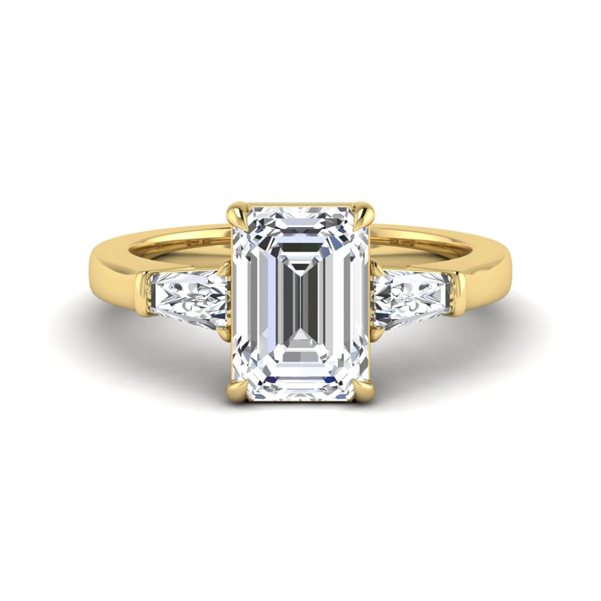 Emerald three stone prong set lab grown diamond engagement ring featuring a 3.00 carat emerald cut center diamond with tapered baguette side diamonds in yellow gold finish.