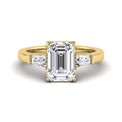 Emerald three stone prong set lab grown diamond engagement ring featuring a 3.00 carat emerald cut center diamond with tapered baguette side diamonds in yellow gold finish.