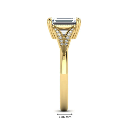 Emerald cut lab grown diamond engagement ring with round diamond split shank, milgrain detailing, and classic four prong setting in yellow gold