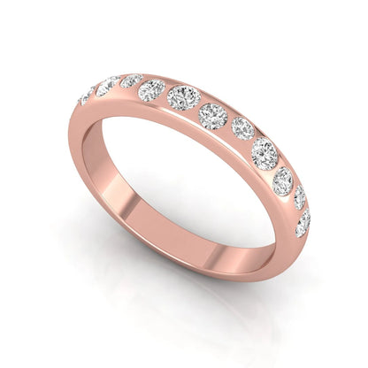 Flush set graduated round cut lab grown diamond band ring in polished rose gold with a modern half eternity design.