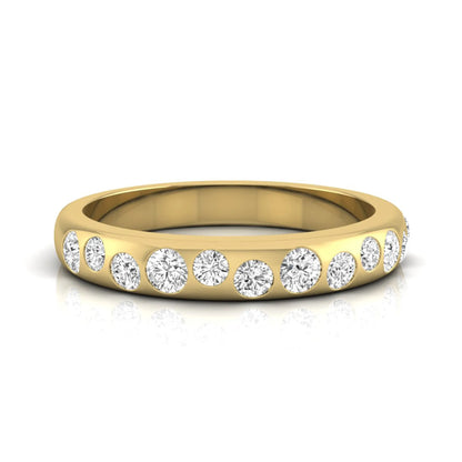 Flush set graduated round cut lab grown diamond band ring in polished yellow gold with a modern half eternity design.