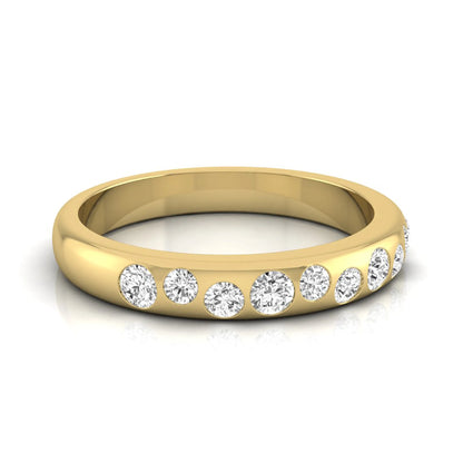 Flush set graduated round cut lab grown diamond band ring in polished yellow gold with a modern half eternity design.