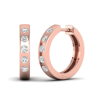 Flush set round cut lab grown diamond huggie hoop earrings featuring a polished rose gold design and hinged snap closure.