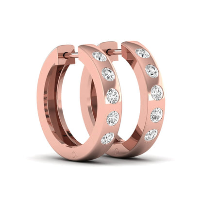 Flush set round cut lab grown diamond huggie hoop earrings featuring a polished rose gold design and hinged snap closure.