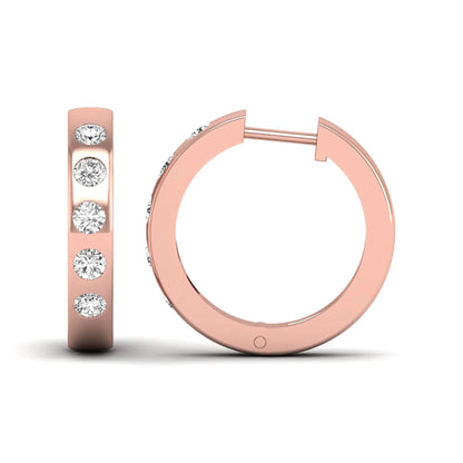Flush set round cut lab grown diamond huggie hoop earrings featuring a polished rose gold design and hinged snap closure.