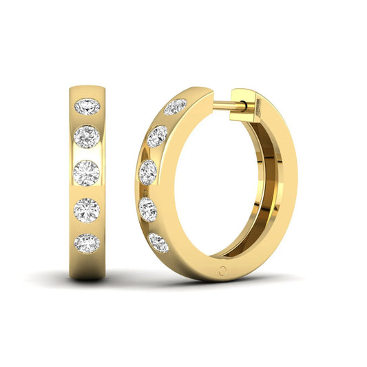 Flush set round cut lab grown diamond huggie hoop earrings featuring a polished yellow gold design and hinged snap closure.