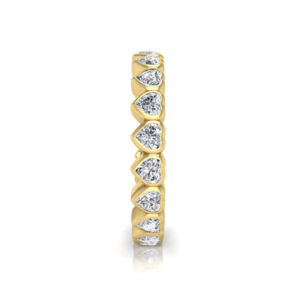 Heart cut lab grown diamond eternity band featuring 3.20 carats of heart-shaped diamonds in a shared-prong setting with a polished yellow gold finish.