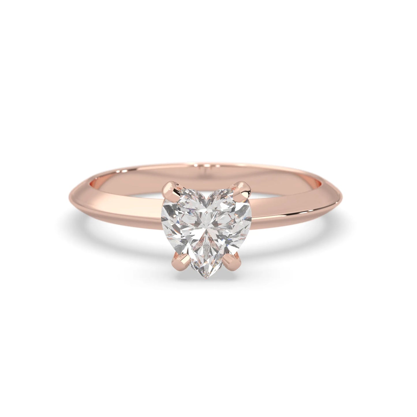Rose-gold ring with a heart-shaped diamond on a white background