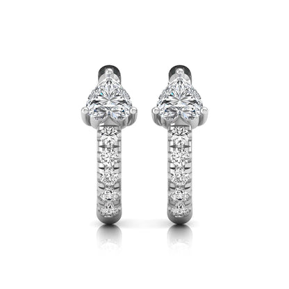 Heart cut lab grown diamond huggie hoop earrings featuring a three prong basket set center diamond with round brilliant pavé diamonds on a white gold hoop.