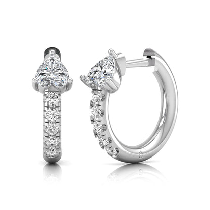 Heart cut lab grown diamond huggie hoop earrings featuring a three prong basket set center diamond with round brilliant pavé diamonds on a white gold hoop.