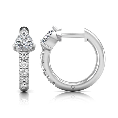 Heart cut lab grown diamond huggie hoop earrings featuring a three prong basket set center diamond with round brilliant pavé diamonds on a white gold hoop.
