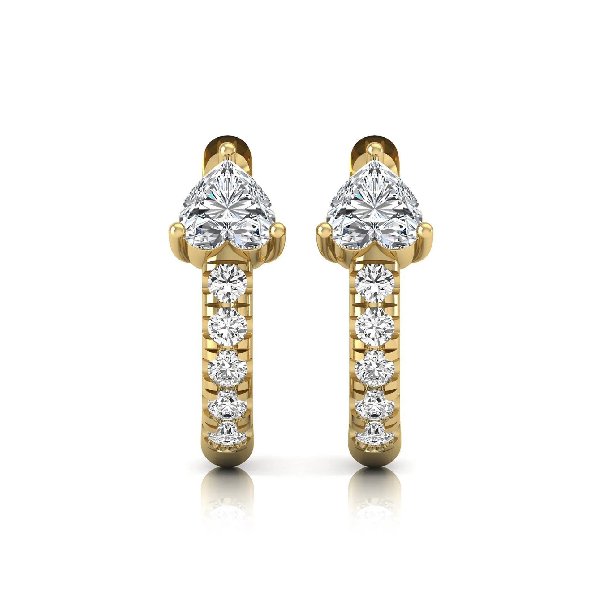 Heart cut lab grown diamond huggie hoop earrings featuring a three prong basket set center diamond with round brilliant pavé diamonds on a yellow gold hoop.