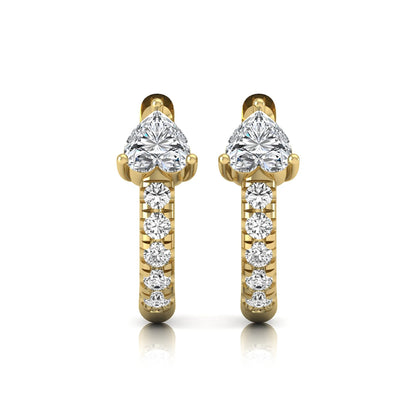 Heart cut lab grown diamond huggie hoop earrings featuring a three prong basket set center diamond with round brilliant pavé diamonds on a yellow gold hoop.