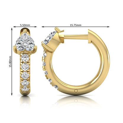 Heart cut lab grown diamond huggie hoop earrings featuring a three prong basket set center diamond with round brilliant pavé diamonds on a yellow gold hoop.