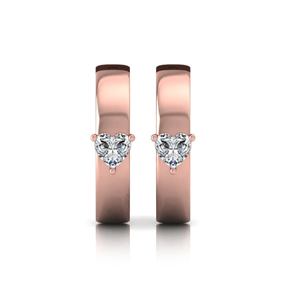 Heart cut lab grown diamond huggie hoop earrings featuring a classic four prong setting and hinged snap closure shown in rose gold tone with a polished finish.