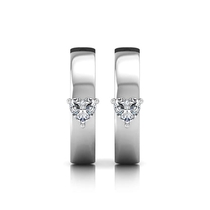 Heart cut lab grown diamond huggie hoop earrings featuring a classic four prong setting and hinged snap closure shown in white gold tone with a polished finish.