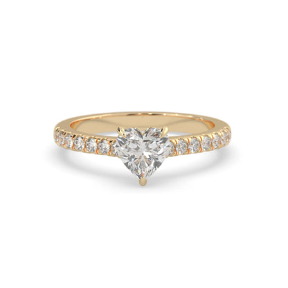 heart cut lab grown diamond prong set engagement ring with pavé band and yellow gold metal tone design