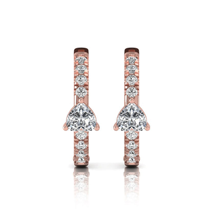 Heart and round cut lab grown diamond pavé huggie hoop earrings featuring a front-facing heart diamond, graduated shared prong round diamonds, hinged snap closure, and polished rose gold finish.