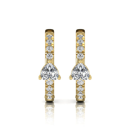 Heart and round cut lab grown diamond pavé huggie hoop earrings featuring a front-facing heart diamond, graduated shared prong round diamonds, hinged snap closure, and polished yellow gold finish.