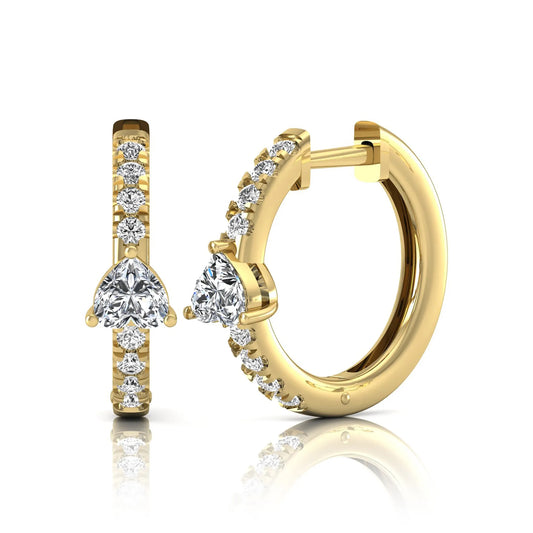 Heart and round cut lab grown diamond pavé huggie hoop earrings featuring a front-facing heart diamond, graduated shared prong round diamonds, hinged snap closure, and polished yellow gold finish.