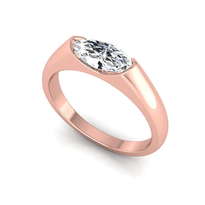 Marquise cut lab grown diamond engagement ring with bezel setting and polished rose gold tone tapered band
