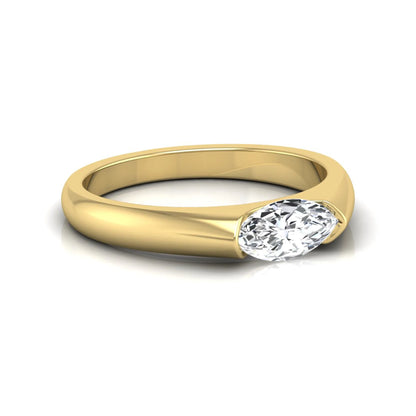 Marquise cut lab grown diamond engagement ring with bezel setting and polished yellow gold tone tapered band