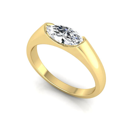 Marquise cut lab grown diamond engagement ring with bezel setting and polished yellow gold tone tapered band