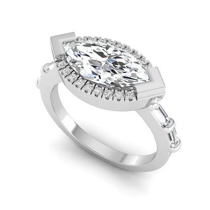 Marquise cut lab grown diamond halo engagement ring with round halo, baguette side diamonds, and white gold tone band.