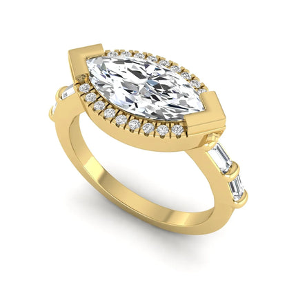 Marquise cut lab grown diamond halo engagement ring with round halo, baguette side diamonds, and yellow gold tone band.