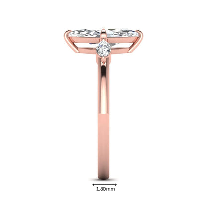 Marquise cut lab grown diamond three stone engagement ring featuring a 1.62 carat IGI certified center diamond with marquise side diamonds in rose gold.