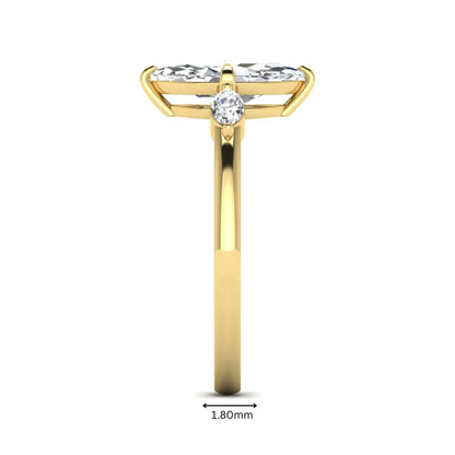 Marquise cut lab grown diamond three stone engagement ring featuring a 1.62 carat IGI certified center diamond with marquise side diamonds in yellow gold.