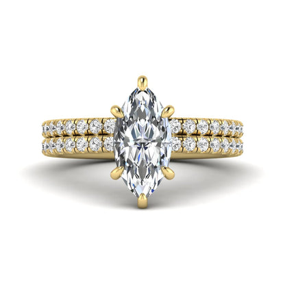 Marquise cut lab grown diamond bridal ring set featuring a pavé solitaire engagement ring with matching diamond wedding band in yellow gold.