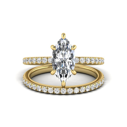 Marquise cut lab grown diamond bridal ring set featuring a pavé solitaire engagement ring with matching diamond wedding band in yellow gold.