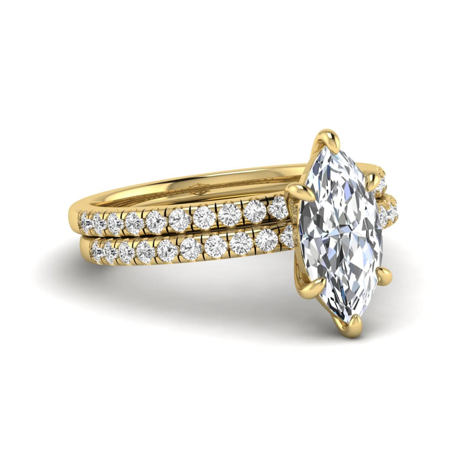 Marquise cut lab grown diamond bridal ring set featuring a pavé solitaire engagement ring with matching diamond wedding band in yellow gold.
