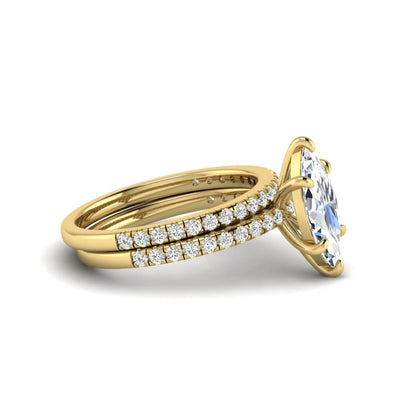 Marquise cut lab grown diamond bridal ring set featuring a pavé solitaire engagement ring with matching diamond wedding band in yellow gold.