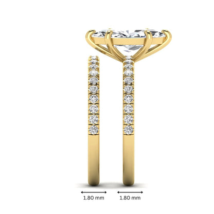 Marquise cut lab grown diamond bridal ring set featuring a pavé solitaire engagement ring with matching diamond wedding band in yellow gold.