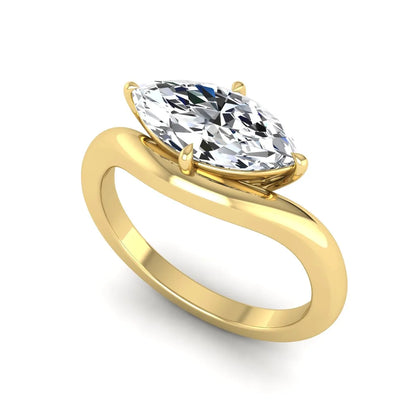 Marquise cut lab grown diamond solitaire engagement ring featuring a four prong cathedral setting with a polished 2 mm band in yellow gold tone.