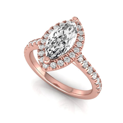 Marquise cut lab grown diamond engagement ring featuring a round diamond halo, pavé diamond band, and classic prong setting with a polished rose gold tone band.
