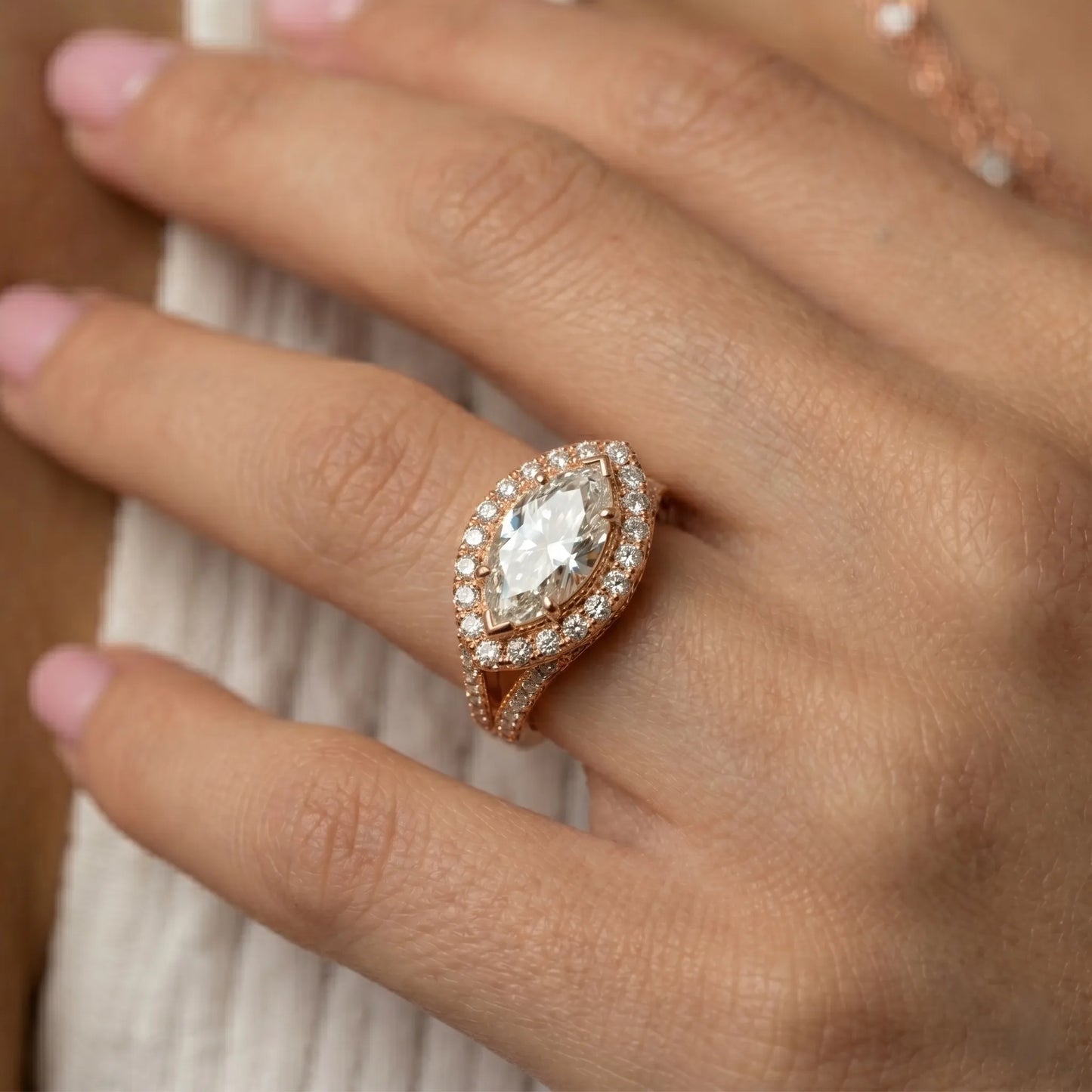 Rose-gold ring with a large diamond on a hand