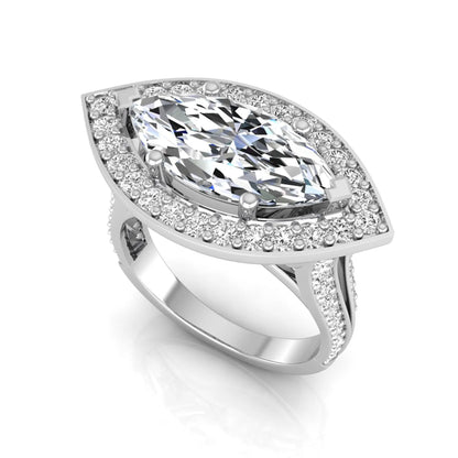 white-gold ring with a large central gemstone and smaller stones on a white background