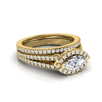 Marquise cut lab grown diamond halo engagement ring set with split shank design and matching pavé diamond wedding band in yellow gold.